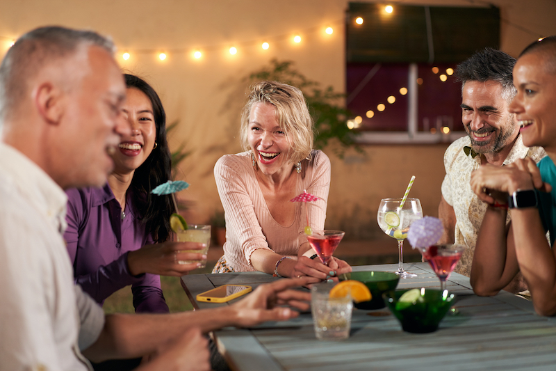 Middle-aged Mature People Having Cocktails Party Together. Group Of Friends Cheering Drink Glasses C